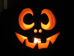 smiling jack o lantern with lit candle