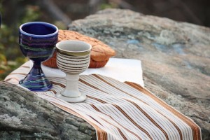 Communion chalices and bread on rock outcropping