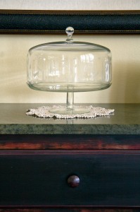 glass pedestal cake saver with dome and doily