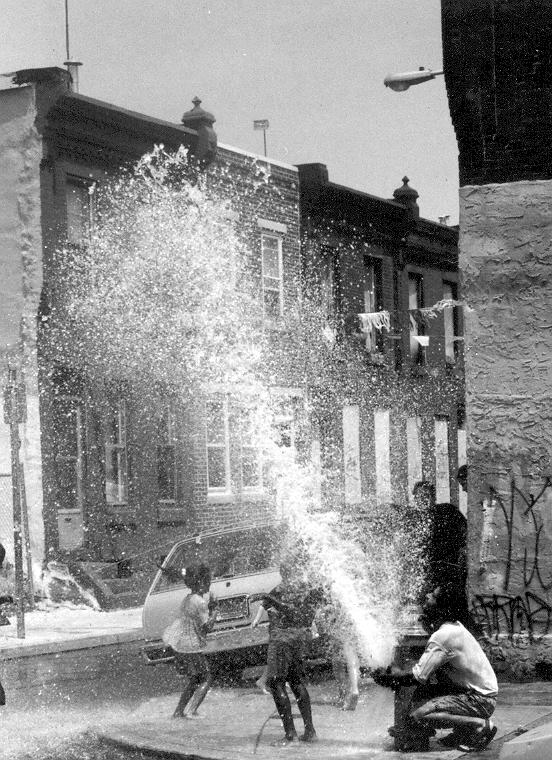 fire hydrant spraying on city block in philadelphia